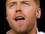 Ronan Keating and Stephen Gatley perform with Boyzone at a concert in Liverpool