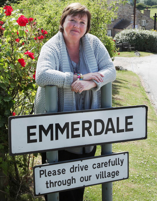 Pauline Quirke by the Emmerdale sign