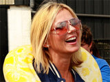 Geri Haliwell makes a reptilian friend at a fundraising event