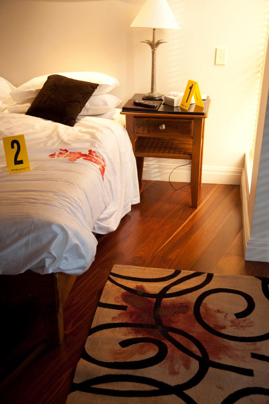 Charlie Buckton examines a crime scene in Home and Away