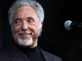 Tom Jones performs on stage at Newbury racecourse.