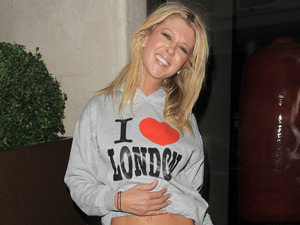 Tara Reid exposes her midriff outside the MayFair hotel in central London