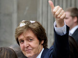 Sir Paul gives his trademark thumbs-up to fans after the 45-minute ceremony.