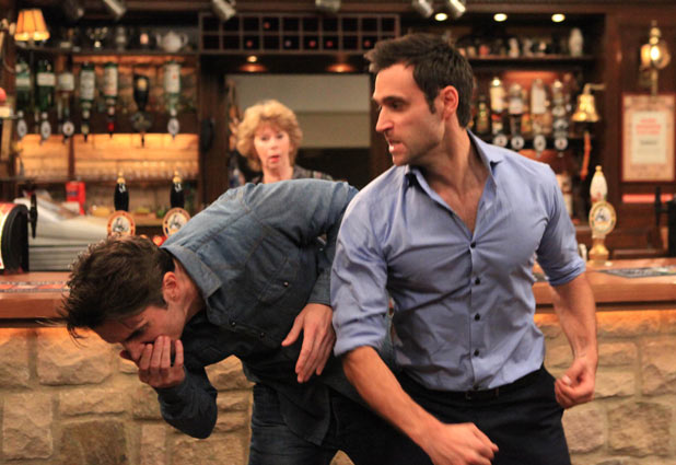 Nikhil Sharma (Rik Makarem) punches Nicky Pritchard (Matt Milburn)