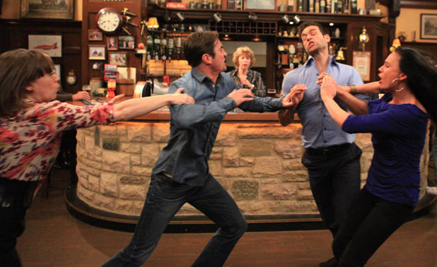 Nikhil Sharma (Rik Makarem) punches Nicky Pritchard (Matt Milburn)