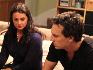 John is annoyed that Moira has stayed to help cook dinner