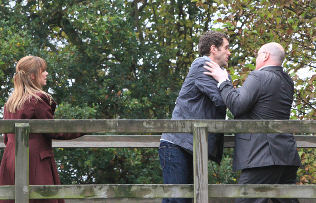 Paddy grabs Marlon by the shoulders as he attempts to get passed him
