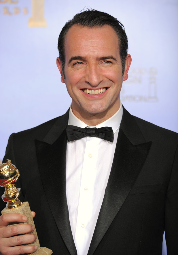 Actor Jean Dujardin poses backstage with the award for Best Motion Picture - Comedy or Musical for the film "The Artist"