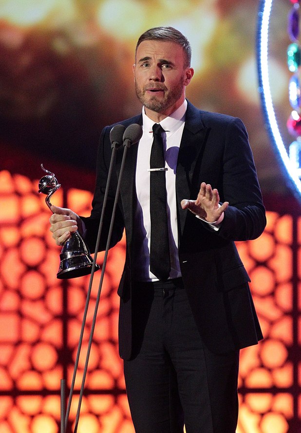 Gary Barlow collects the award for Outstanding Contribution during the 2012 NTA Awards
