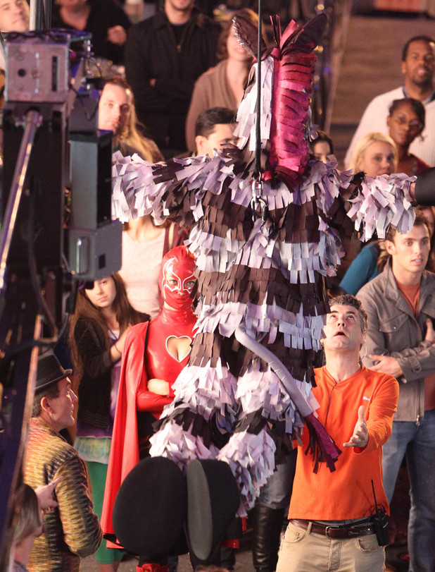 Olivia Wilde in a superhero costume and Jim Carrey as a Zebra pinata
