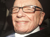 Rupert Murdoch, head of News Corp leaving his Mayfair home in a car.