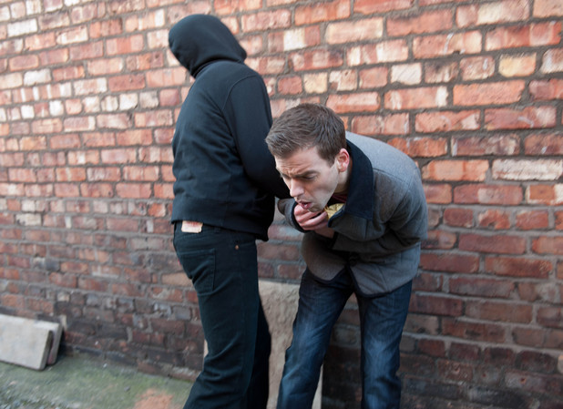 Doug's attacker takes the parcel he was delivering for Brendan.