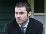 Aaron waits at the cricket pavilion in his suit, as he thinks about the day ahead and his impending court case