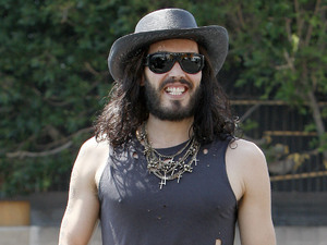 Russell Brand wearing ripped jeans and boots and a straw stetson hat, out and about in West Hollywood. Los Angeles, California