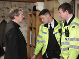 Just as the police are about to leave, Ashley arrives and informs them that he will cooperate fully with them. A distraught Sandy looks on
