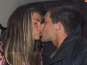 Katie Price and boyfriend Leandro Penna hug and kiss in the back of a taxi.