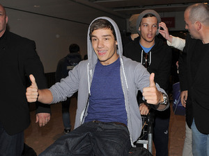 Liam Payne and Louis Tomlinson
One Direction arrive at Heathrow Airport on alate night flight from Sweden. Despite it being almost midnight, they were swamped by around 70 female fans as they made their way to their car.
London