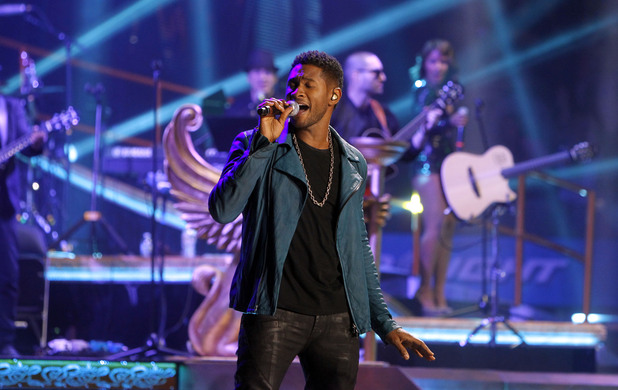 Usher performing at a Romeo Santos concert at Madison Square Gardens, February 2012