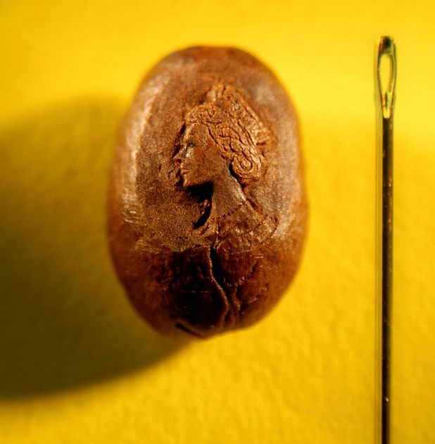 A portrait of the Queen on a coffee bean