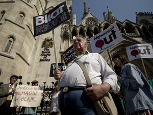 Anti-war protesters demonstrate outside the Royal Courts of Justice on the day former British Prime Minister Tony Blair was appearing at the Leveson media ethics inquiry in London