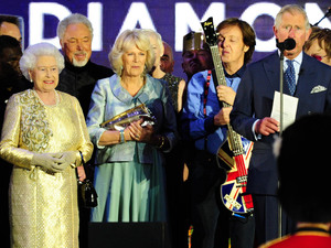 Queen Elizabeth II, Prince Charles and the Duchess of Cornwall on stage outside Buckingham Palace during the Diamond Jubilee Concert.