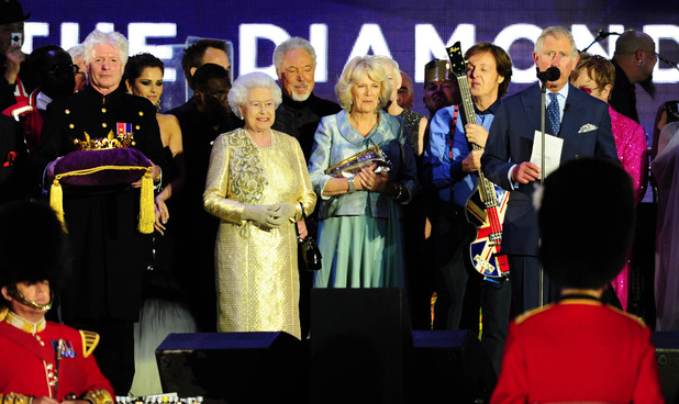 Queen Elizabeth II, Prince Charles and the Duchess of Cornwall on stage outside Buckingham Palace during the Diamond Jubilee Concert.