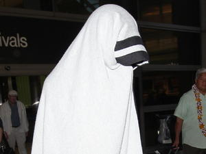 Katy Perry
covers herself in a large Chanel beach towel to avoid having her photograph taken by waiting paparazzi as she arrives back into LAX airport
Los Angeles