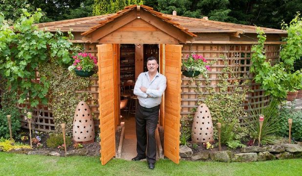 John Plumridge outside his winning 'Woodhenge' pub shed in Shrewsbury, Shropshire