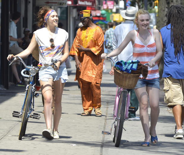 Dakota Fanning and Elizabeth Olsen filming a scene with bicycles
on the set of 'Very Good Girls'. The movie is a coming-of-age drama which tells the story of two girls who fall for the same street artist
New York City, USA