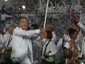 Sir Chris Hoy holds the Union Jack as he lead the GB team into the Stadium for the London Olympic Games 2012 Opening Ceremony