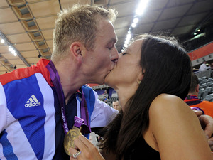 Sir Chris Hoy kisses his wife Sarra as they celebrate his gold medal win at the Velodrome
