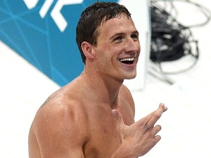 USA swimmer Ryan Lochte smiles toward fans and has his fingers crossed after he claimed the gold medal in the Men's 400m Individual Medley