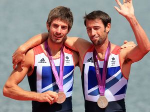 Great Britain's Mark Hunter and Zac Purchase are completely overcome after winning silver in the final of the lightweight men's double sculls.