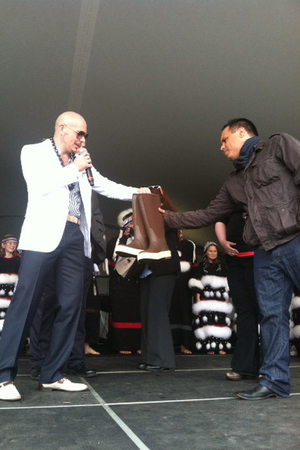 Pitbull is presented with a Walmart care package during a personal appearance in Kodiak, Alaska