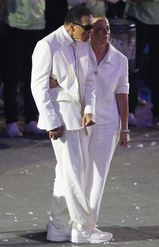 Muhammad Ali and his wife Lonnie get ready to take the flag.