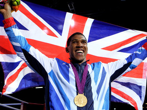 Anthony Joshua celebrates with his Gold medal following his Super Heavy Weight Final against Italy's Roberto Cammarelle.