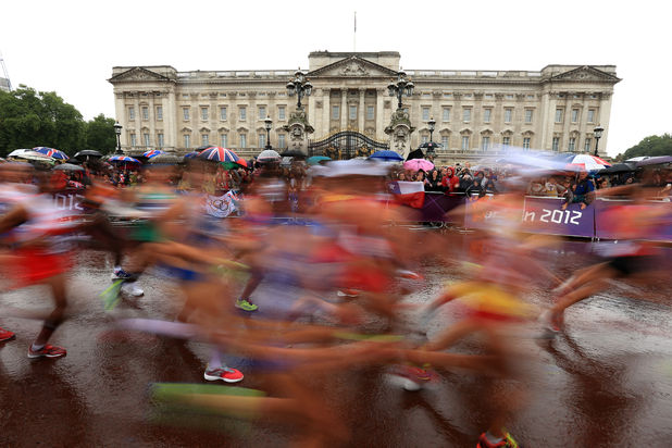 Runners in the women's marathon run past Buckingham Palace, London