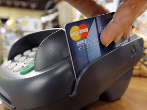 A customer swipes a MasterCard debit card through a machine