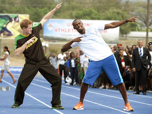 Prince Harry with Olympic sprint champion Usain Bolt doing his signature sign after a short sprint, at the University of the West Indies, in Jamaica where the Prince arrived late yesterday afternoon from The Bahamas.