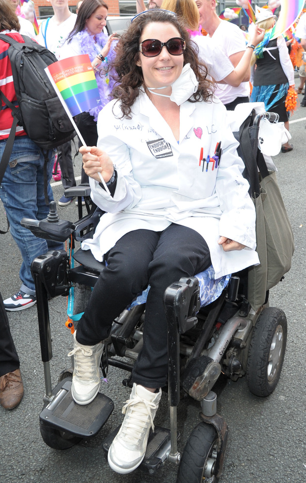 Cherylee Houston waves her rainbow flag for pride.
