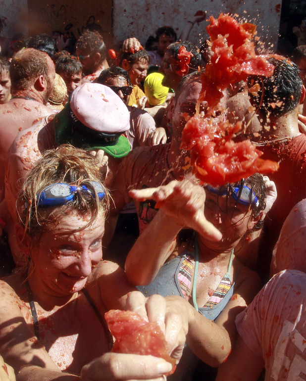 Revellers throw tomatoes at the annual La Tomatina festival in Bunol, Valencia, Spain (August 29, 2012)