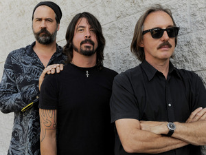 Krist Novoselic, left, and Dave Grohl, center, former members of the band Nirvana, pose with Butch Vig, producer of the band's landmark 1991 album "Nevermind," poses in Los Angeles.