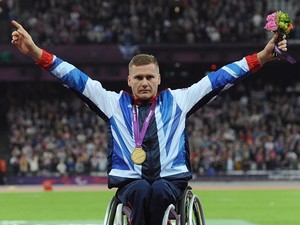 Great Britain's David Weir celebrates with his gold after winning the Men's 800m - T54, during the Paralympic Games in London.