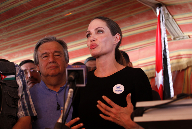 The U.N. refugee agency's special envoy, actress Angelina Jolie, center, arrives to the Zaatari Refugees Camp in Jordan for Syrians who fled the civil war in their country
