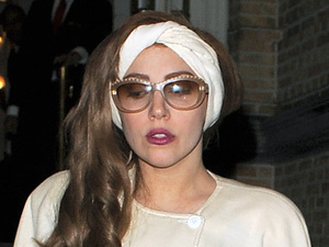 Lady Gaga
leaves her hotel late at night and has pictures taken with her fans, who had waited for hours to see her, before getting on a tour bus to take her to Berlin. Lady Gaga also had an assistant handing out free samples of her new perfume, 'Fame' to the fans who had waited all day and night for the singer to emerge from her hotel.
Amsterdam, Netherlands