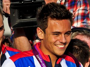 Plymouth based Olympic and Paralympic athletes, including Tom Daley (left) aboard an open top bus as they process through the streets of Plymouth, where thousands of people have turned out to welcome them home from the games (19/09/2012)