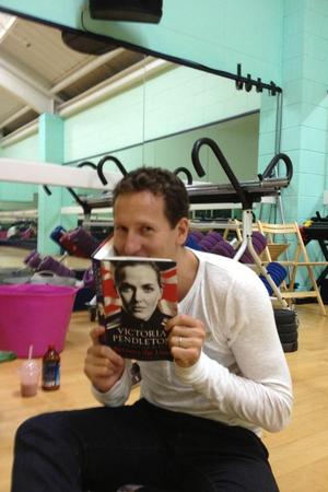 Strictly Come Dancing's Brendan Cole poses with Victoria Pendleton's memoirs during a rehearsal sesson