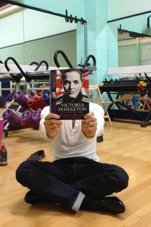 Strictly Come Dancing's Brendan Cole poses with Victoria Pendleton's memoirs during a rehearsal sesson