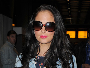 Tulisa Contostavlos arriving at Heathrow Airport on a late night flight from Glasgow. Tulisa was carrying a copy of 'Fifty Shades of Grey', a bestselling erotic fiction paperback, written by E. L. James. It is notable for its explicitly erotic scenes.
London, England - 20.05.12
Mandatory Credit: Will Alexander/WENN.com