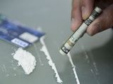 Money and a rolled up note being used for snorting lines of cocaine